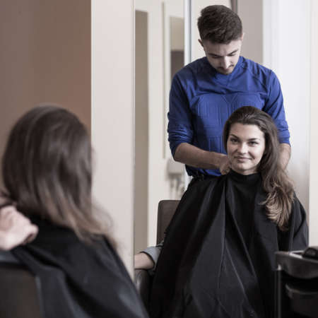 Image of male hairdresser and attractive womanの写真素材