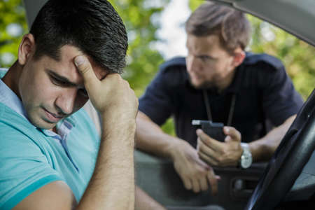 Young driver is very devastated because of arrestの写真素材