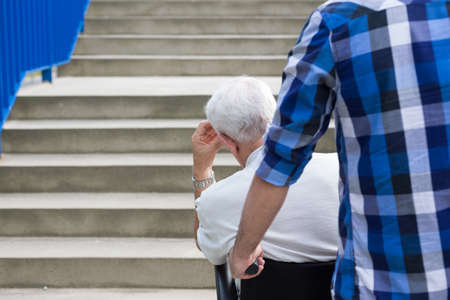 Senior man and dangerous city barriers for wheelchairの写真素材