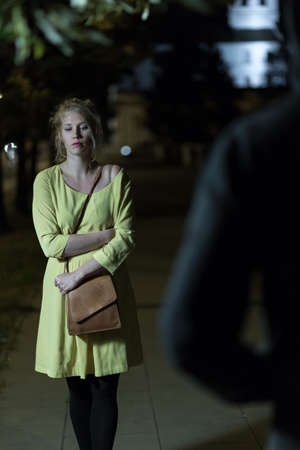 Robber going to steal purse on the streetの写真素材