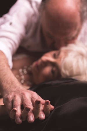 Shot of a senior man kissing his wife on the neckの写真素材