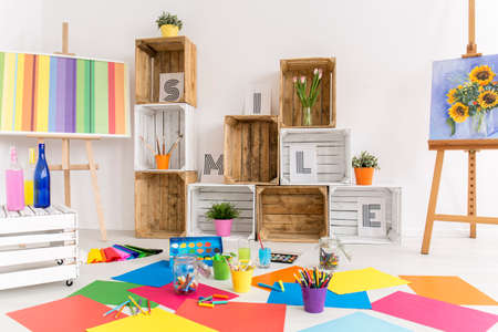 Shot of a modern room with lots of colorful papers on the floorの写真素材
