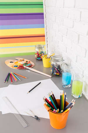 Shot of a desk full of paints and crayonsの写真素材