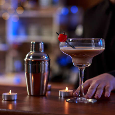 Young woman ordering a drink in bar