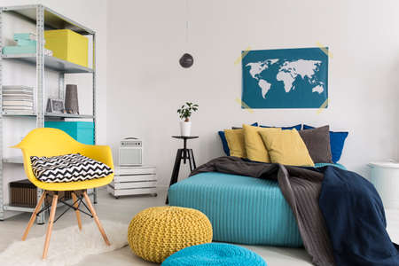 Shot of a modern blue and yellow bedroomの写真素材