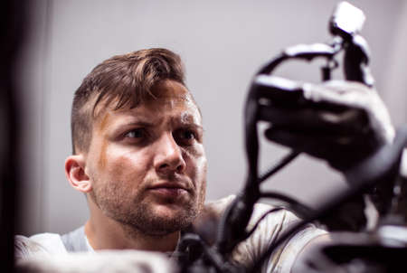 Car mechanic is very precise and centred at the workの写真素材