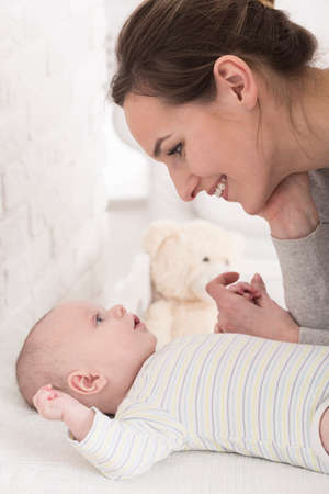Shot of a happy young mum looking at her little baby