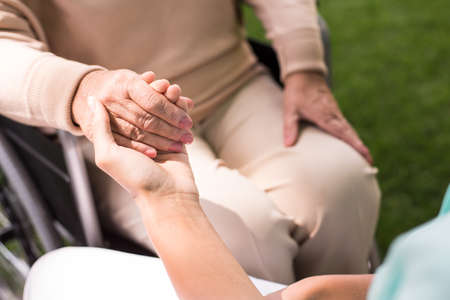 Close-up of nurse holding her ward's handの写真素材