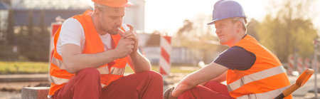 Panorama of tired construction workers having break