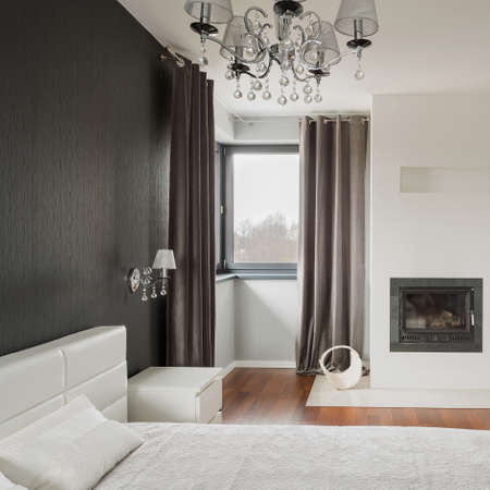 Old fashioned stylish bedroom with fireplaceの写真素材