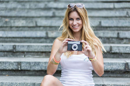 Pretty girl is taking a picture, horizontalの写真素材