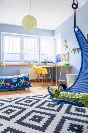 Modern schoolboy's room arranged in blue and white, with lots of practical accessoriesの写真素材