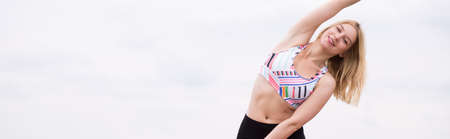 Young woman doing aerobic exercise outdoor in the morningの写真素材