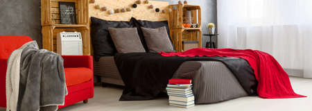Shot of a modern grey black and red beddroom