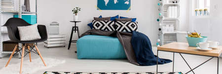 Modern minimalist turquoise and white bedroom with double bed
