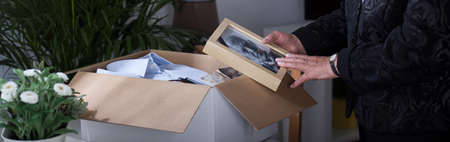 Widow with her dead husband's framed photoの写真素材