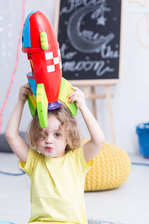Shot of a little boy playing with his toy rocketの写真素材