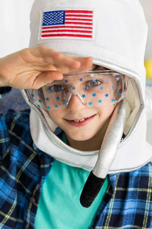 Shot of a little boy wearing a toy space helmetの写真素材