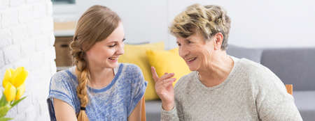 Shot of an elderly woman telling her granddaughter a funny story