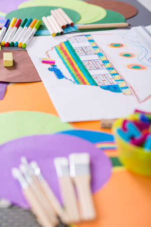 Colorful paper, picture and artistic accessories lying on a tableの写真素材