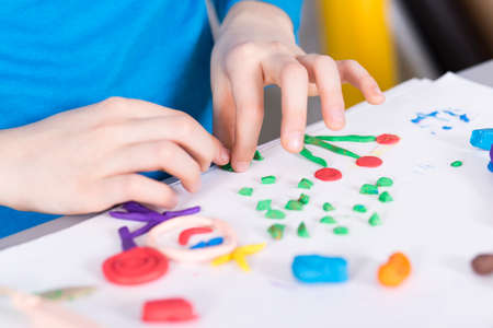 Close up of a child doing picture from plasticineの写真素材