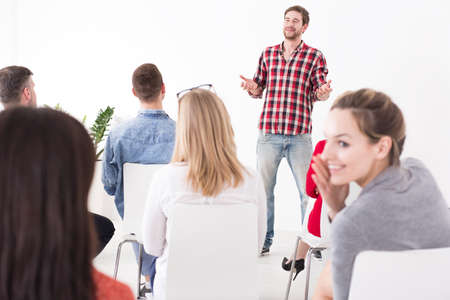 Shot of a young woman whispering to his friend during the manager presentation