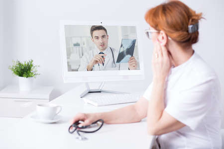 Shot of two doctors having an online conversation