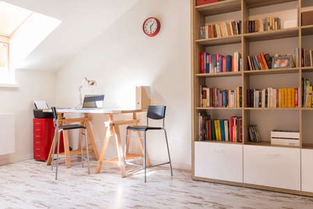 Shot of a modern study with a desk and a bookshelfのeditorial素材
