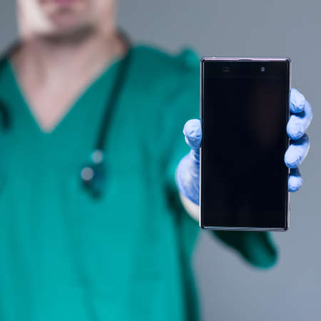 View of male doctor with mobile phoneの写真素材