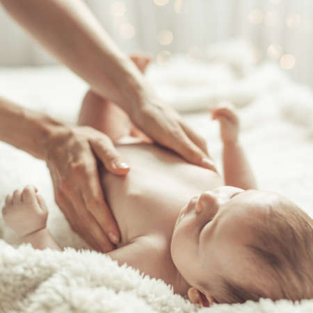 Photo of mother hands gentle touching her cute babyの写真素材
