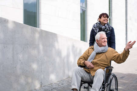 Disabled senior man enjoying a sunny autumn dayの写真素材