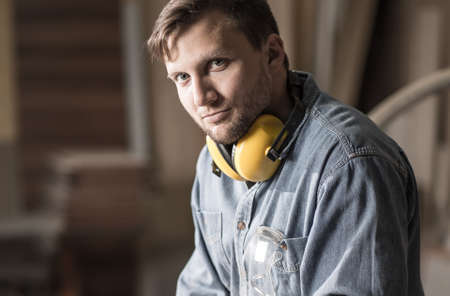 Young carpenter having little break during hard work in carpentryの写真素材