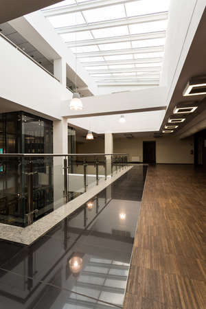 Modern academic interior in black and white with wood flooring
