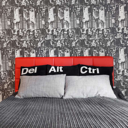 Comfortable bed in contemporary bedroom for young manの写真素材