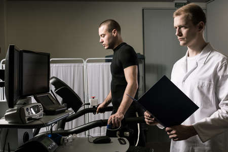 Sportsman and a doctor are focusing before the strength testの写真素材