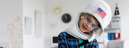 Little spaceman boy playing in his room