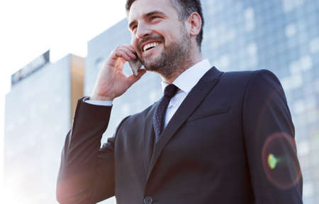 Businessman having conversation with client on the phoneの写真素材