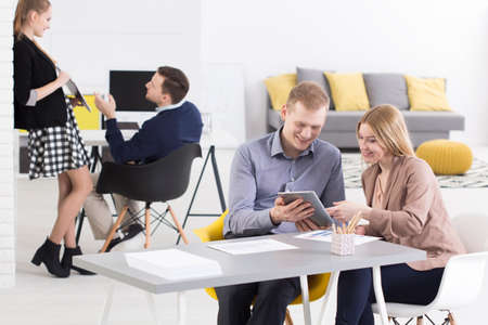 Group of young happy people working in a team in small business company