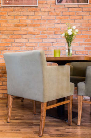 Interior with red brick and comfortable modern armchair