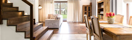View on a bright living room and cozy dining areaの写真素材