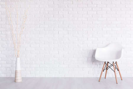 Shot of a white modern room with a chair and a vase