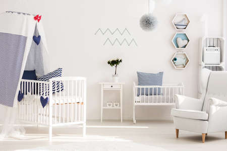 Infant bedroom with simple white furniture and decorations in marine styleの写真素材