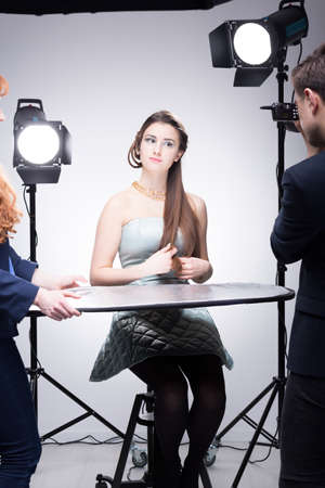 Young model posing for a portrait in a photographic studio equipped with lightingsの写真素材