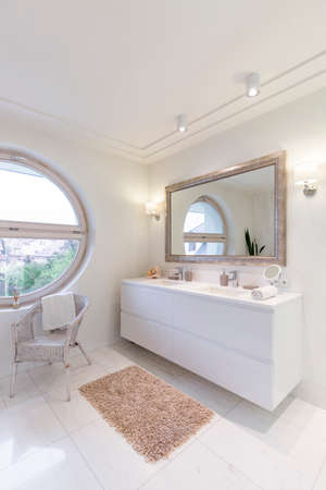 Spacious bathroom with new white glossy tilingの写真素材