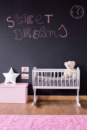 Pink sweet dreams writing on blackboard wall in nursery roomの写真素材