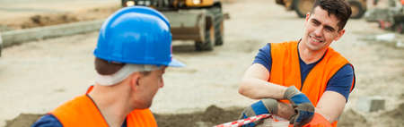 Young construction workers have a break during their work