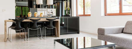 Panoramic picture of a living room connected to the kitchenの写真素材