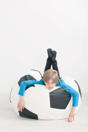 Shot of a little boy laying on a bean bagの写真素材