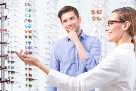 Man choosing a new pair of glasses at an optometristの写真素材