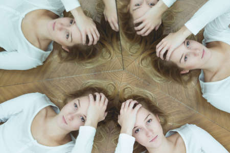 Young woman with split personality and her mirror reflections.の写真素材